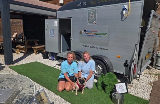 The Wiggle & Wagging Bright Eyes groomers with their mobile grooming salon